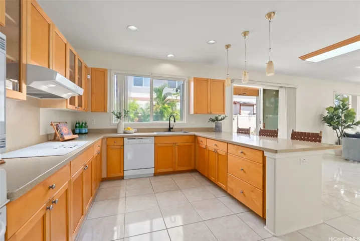 The kitchen includes extensive cabinetry, generous counter space and an open connection to the second living area.