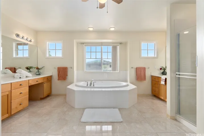 The primary bathroom includes dual sinks, extensive cabinetry and a large vanity area.