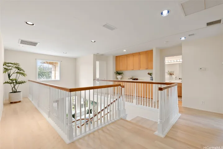 The upstairs landing connects the bedrooms and overlooks the entry below.