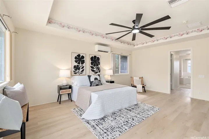 Another view of the primary bedroom shows its size and natural light.