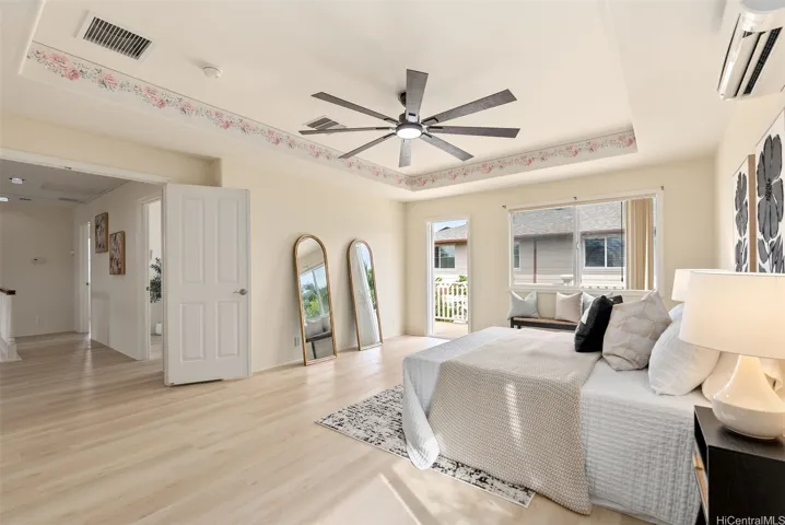 The spacious primary bedroom accommodates a full bedroom set with room for additional furniture.