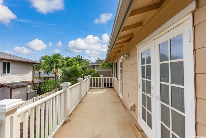 The upstairs lanai provides additional covered outdoor space overlooking the neighborhood.