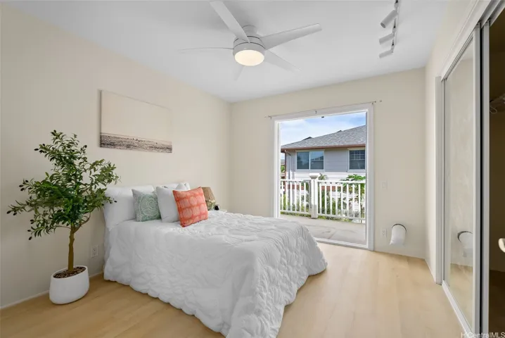This upstairs bedroom includes direct access to the covered lanai.
