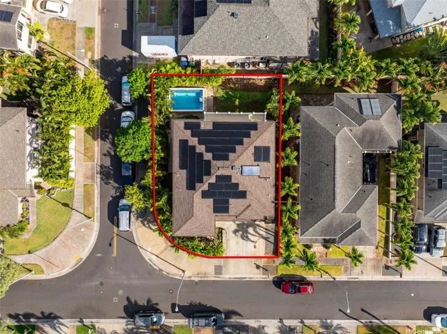 Overhead view of the home, pool, yard and rooftop photovoltaic panels. Any property outline shown is approximate.