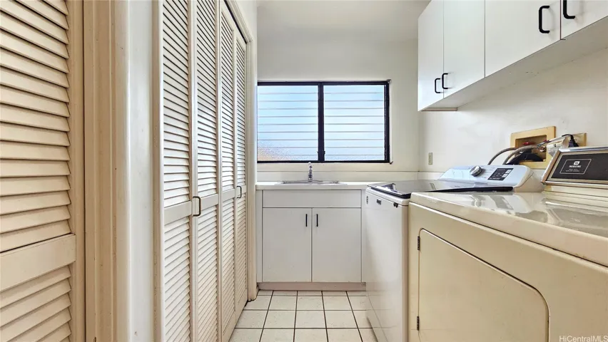 Laundry area with closets