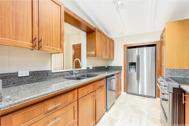 Natural stone counters and Koa wood cabinets, new appliances.