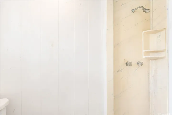 Shower and toilet behind carport