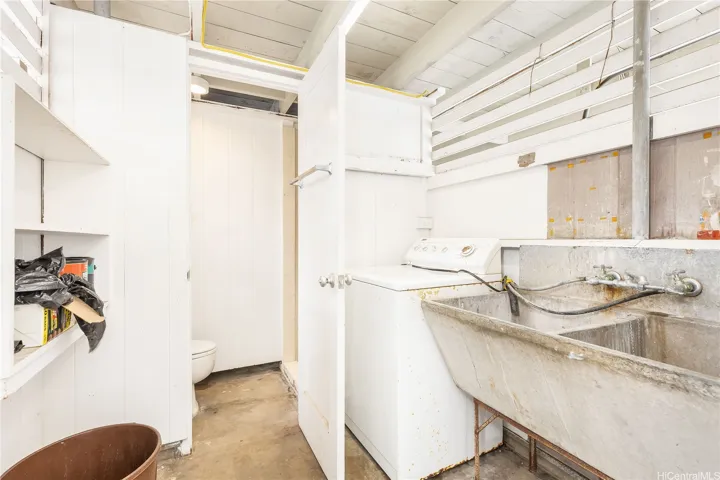 Laundry room behind carport