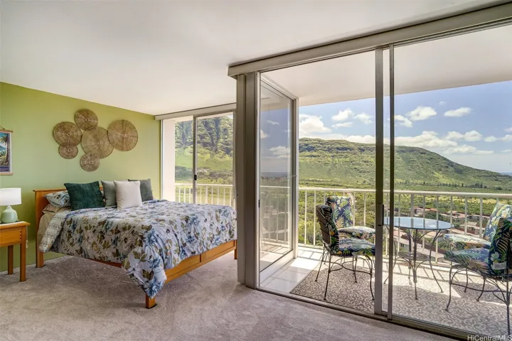 Bright living/sleeping area opens directly to the private lanai with expansive mountain and valley views.