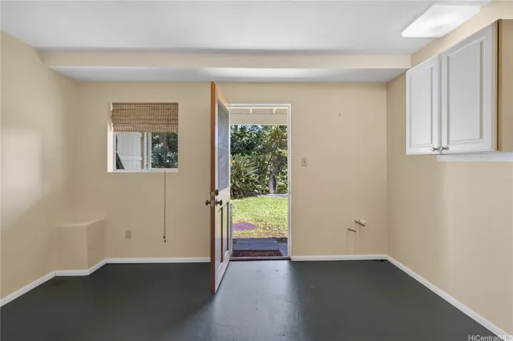 This downstairs room, closer to the interior stairs, has another exterior entrance along with plumbing stub out.  Covered lanai/table and grill area in photos 18 and 21 is outside the door to the right.