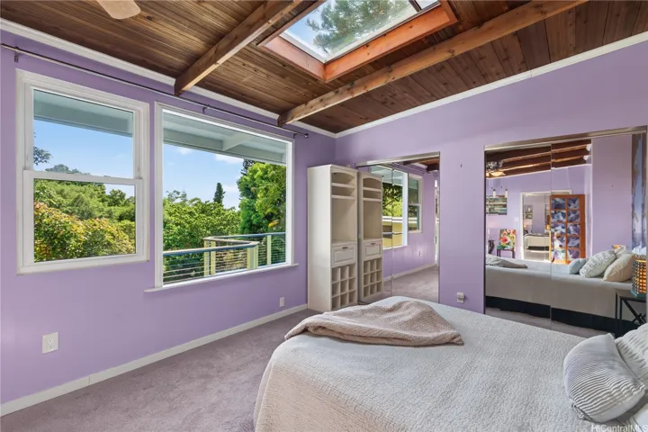 Primary bedroom is oversized with skylights and a view of the yard