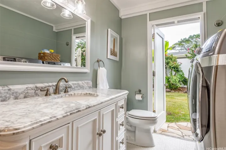 Full bathroom with laundry and access to backyard