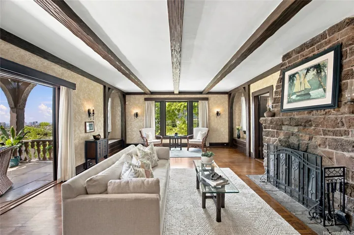 A lava rock wood-burning fireplace is the centerpiece of this gorgeous living room.