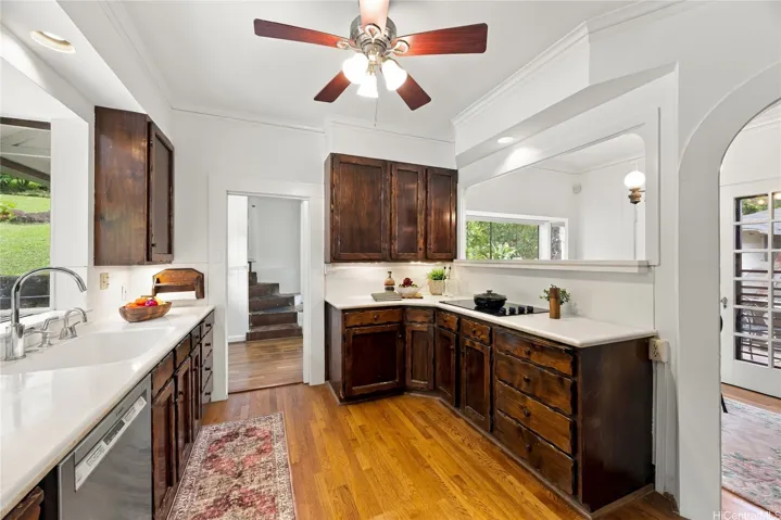 Kitchen has modern appliances and wood floors. The laundry room is just off the kitchen.