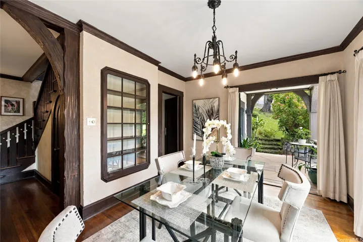 Custom features include  a built-in glass cabinet and wrought iron chandelier.