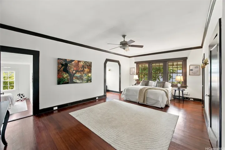 Large primary suite offers natural light with double hung windows and alcove.