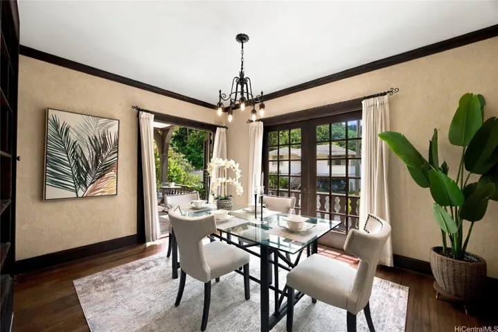Formal dining room featuring textured masonry walls leads to a second patio.