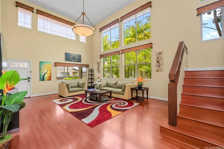 Soaring ceilings and a wall of windows with custom blinds flood this truly "great" room with natural light.