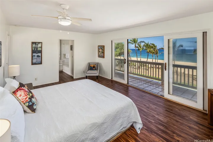 Large primary bedroom on 2nd floor with sweeping sandy beach and ocean views.