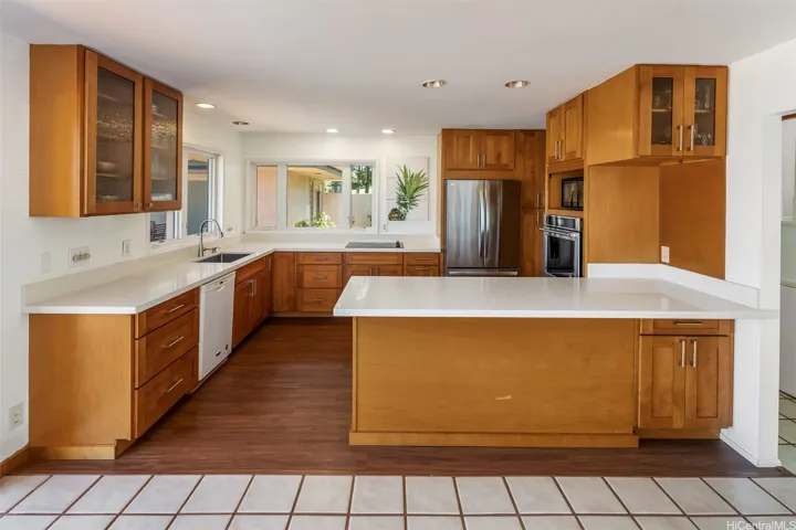 Large open modern kitchen with stainless steel appliances.