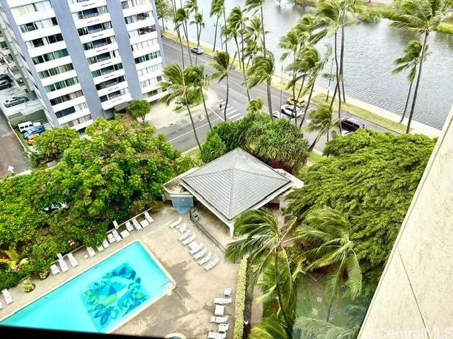 looking down from the livingroom to the pool area and club house
