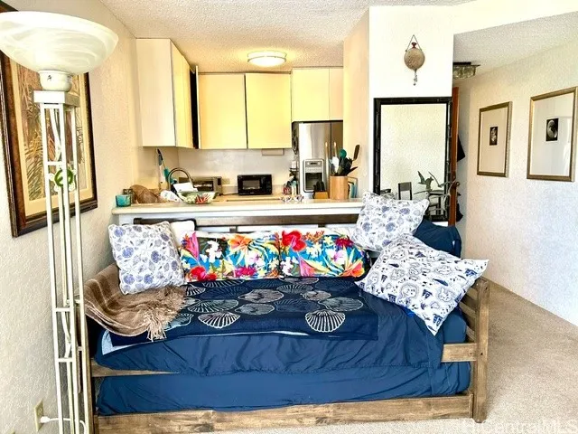 trundle bed looking from living room to the kitchen