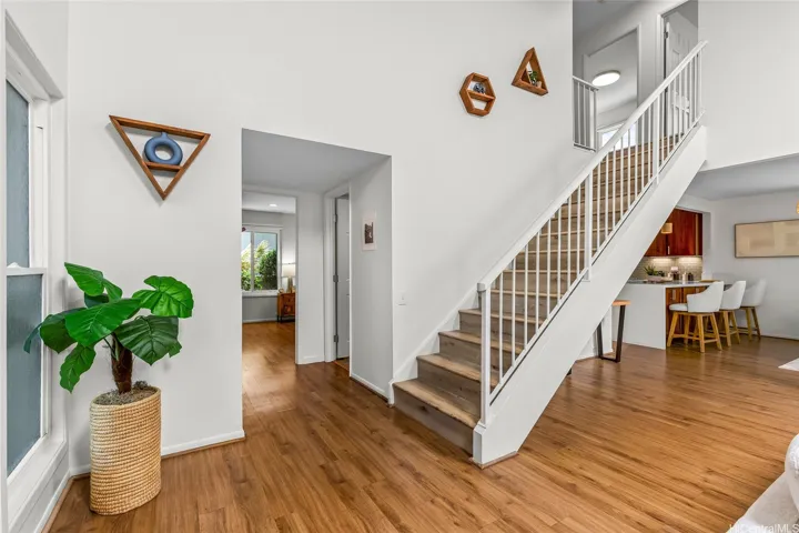 Bedroom on the main level. Stairs leading to the 3 bedroom and 2 full bathrooms upstairs.