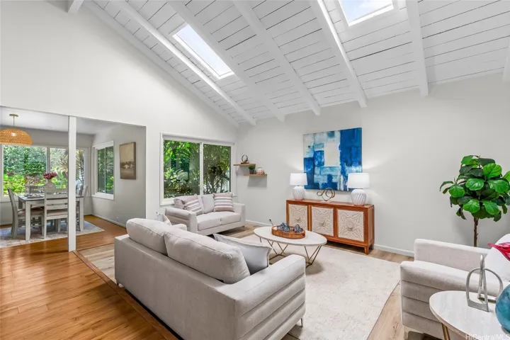 Living room and the dining area to our left. Love the high ceilings and skylight for the natural lighting.