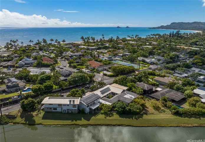 Sprawling canal front estate in the foreground, with the ocean and Mokulua Isles in the distance.
