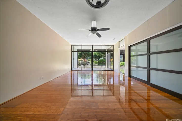 Large living area with lanai access and garden views