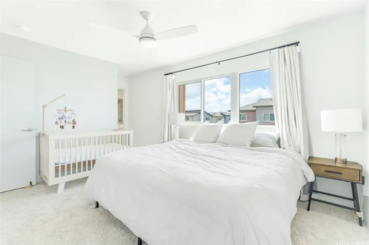 The spacious primary bedroom offers plenty of room for a variety of furnishings and flexible living arrangements.