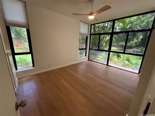 Primary Bedroom with sliding door out to lanai area on pond setting