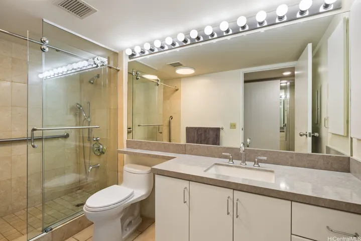 Primary bath with custom shower/sliding door and upgraded granite counter tops and cabs.