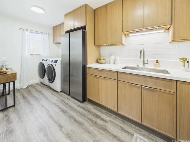 New cabinetry runs wall to wall with full-size laundry steps away