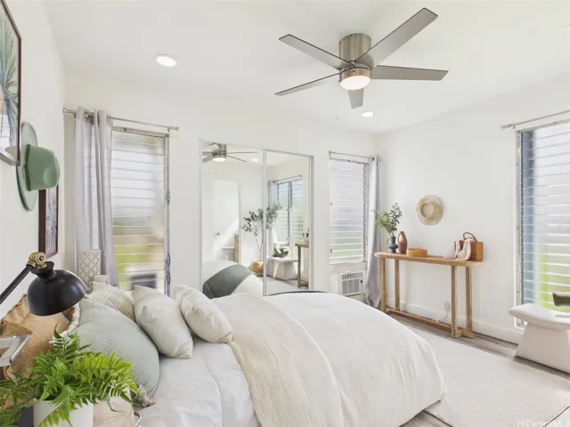Primary bedroom offers windows on two walls for cross-breeze