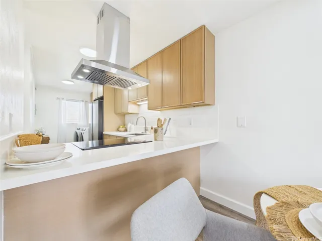 Breakfast bar seating with quartz counters and under-cabinet lighting