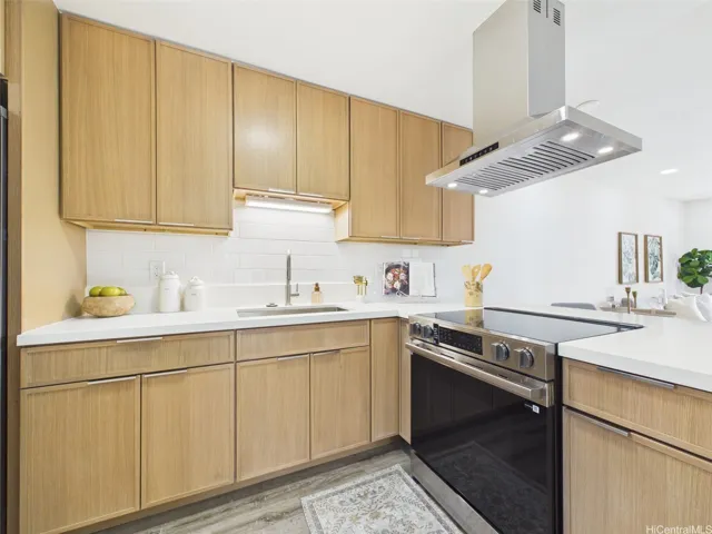 Brand-new kitchen with quartz counters, subway tile, and stainless chimney hood