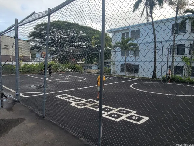 Shoot some hoops, get a little exercise, or give the kids a place to play. The fenced basketball court is conveniently located near the residence, seen in the background.
