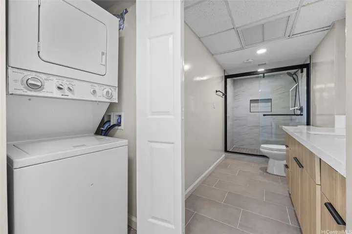 Professionally maintained indoor laundry space with washer and dryer.