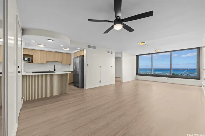 This open-concept kitchen and living area features a thoughtful layout that maximizes space and natural light, perfect for both daily living and entertaining.