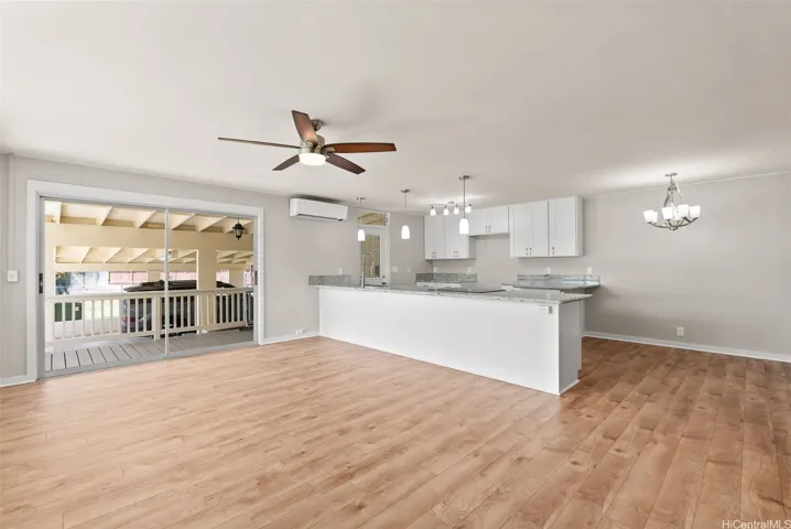 Living area from the entry to open kitchen and patio/deck