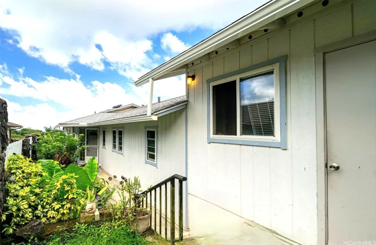Welcoming exterior walkway leading directly to the two-car garage and the inviting front door entry, showcasing the home's convenient accessibility. A generous single level home with so much to offer!