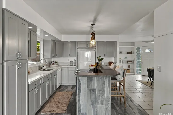 Gourmet kitchen with expansive island, open to dining and living areas for effortless entertaining.
