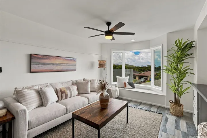 Cozy window seating area located in the living room, offering views of the bay, mountain views & Kaneohe blue skies!