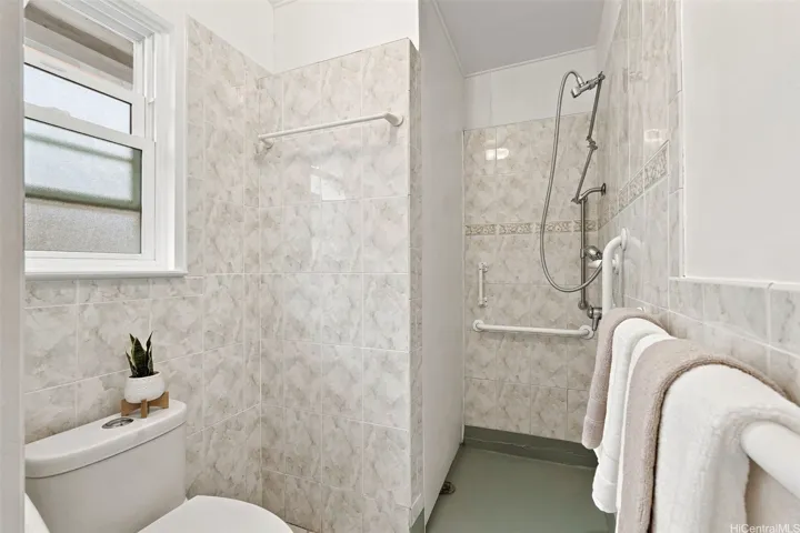 Spacious second primary bedroom with a tiled full bathroom.
