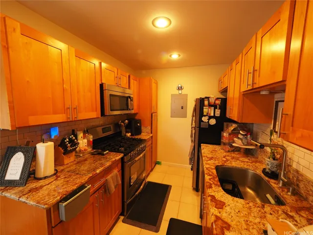 A "galley kitchen" fit for a King or Queen with quallty material finishes and the requisite Gas stove.