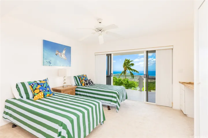 Third bedroom with sliding doors opening to the private, enclosed outdoor space.