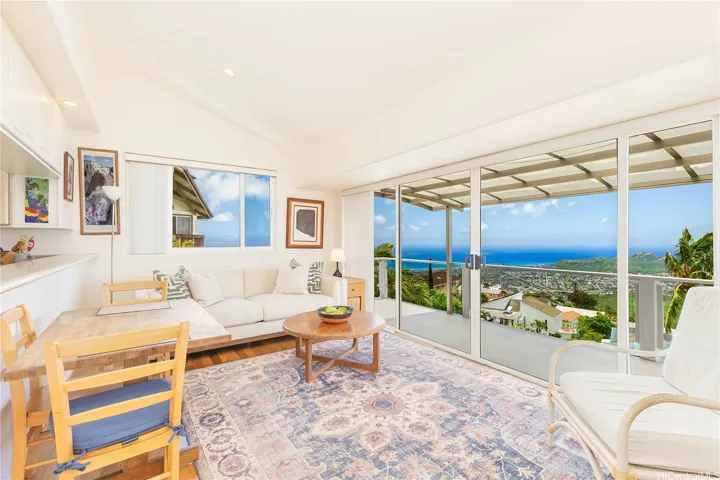 A spacious lounging and dining area sits comfortably adjacent to the kitchen.