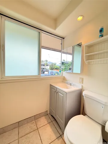 Brand new vanity, cabinet and countertop in bathroom with LED lighting