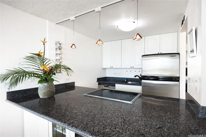 Kitchen features granite counter tops and stainless steel appliances.